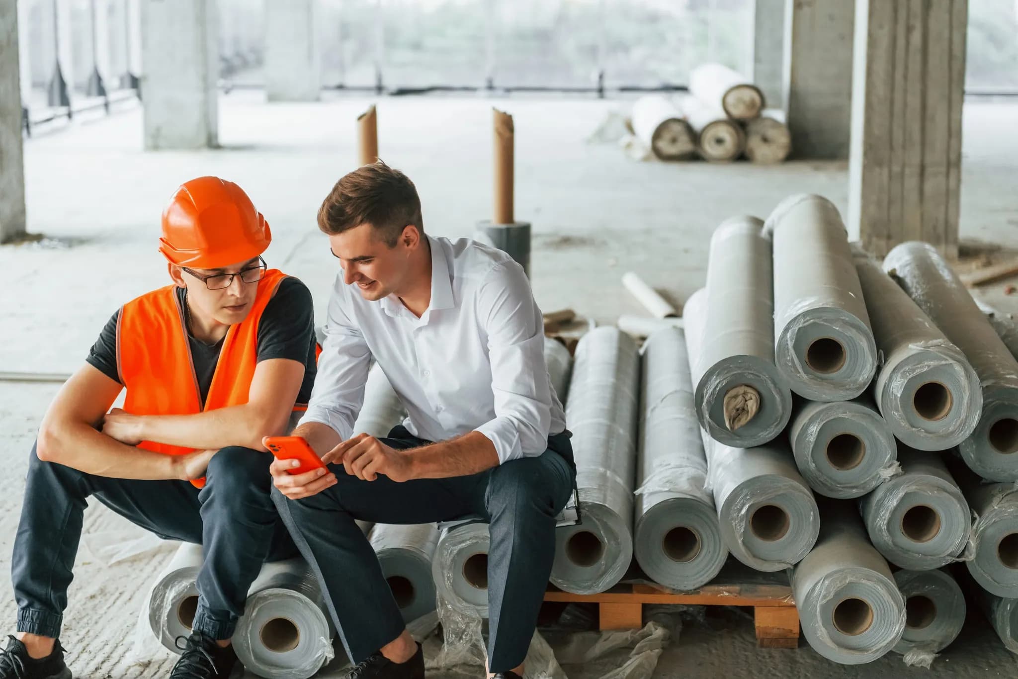 A project manager and a client discussing materials on site